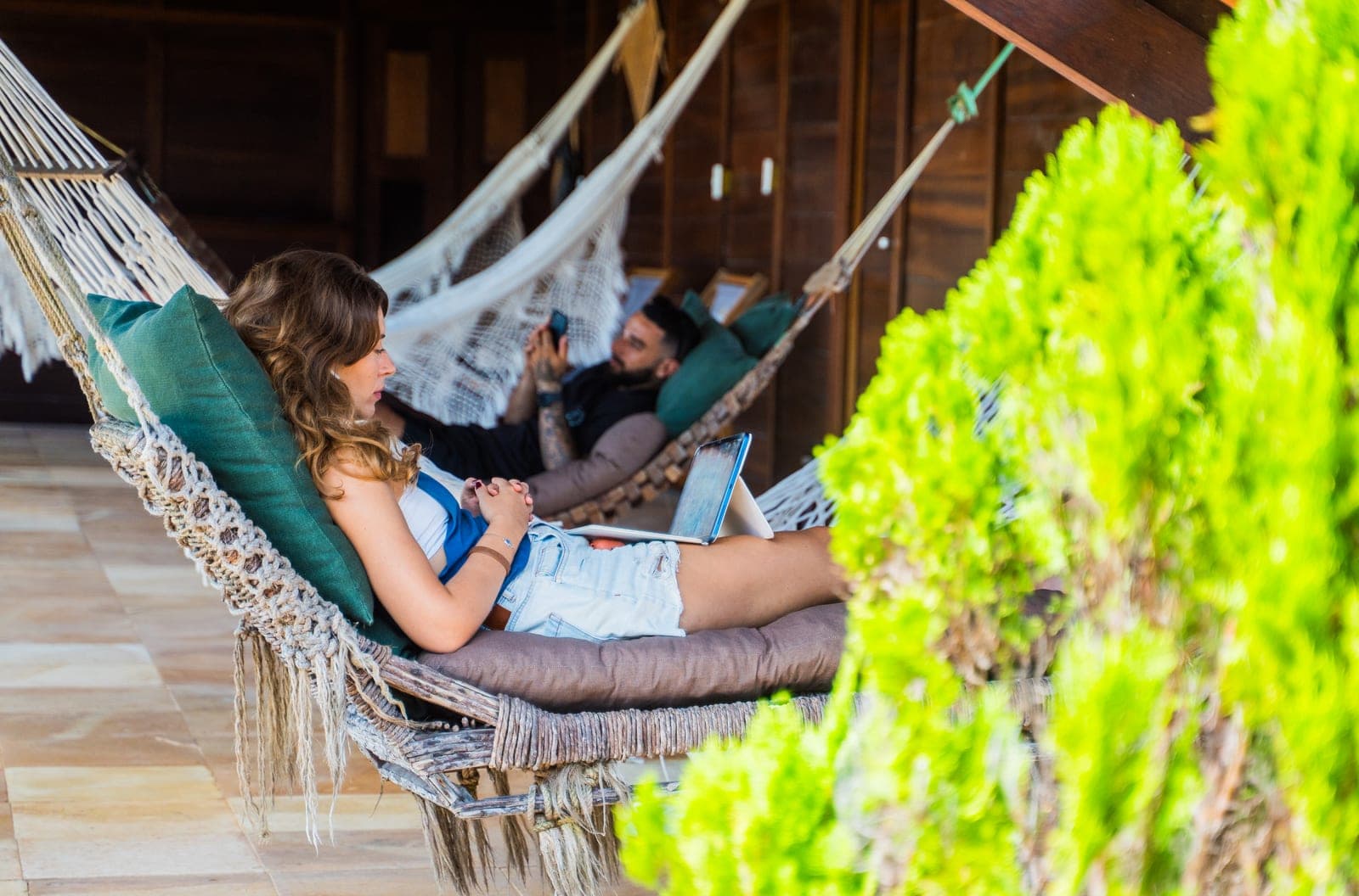 Couple relaxing in hammocks