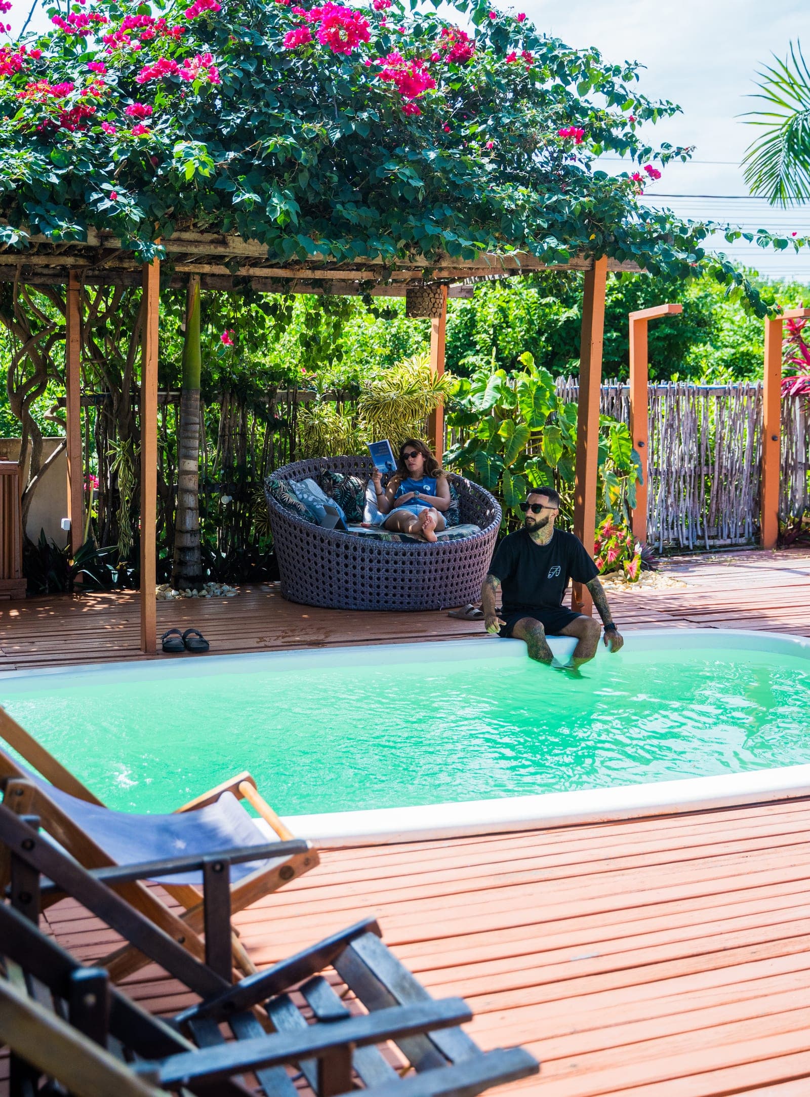 Piscina sob o pergolado florido